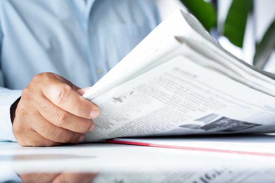 A man holding a newspaper